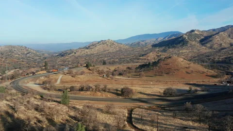 Three-car train on the famous Tehachapi Loop helix - parallax aerial view Stock Footage 149102214