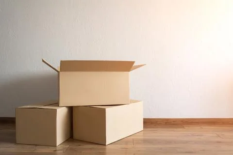 Three cardboard boxes in an empty apartment Stock Photos