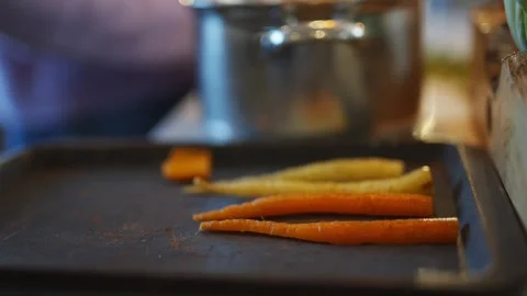 Three carrots are on a black tray Stock Footage 295367682