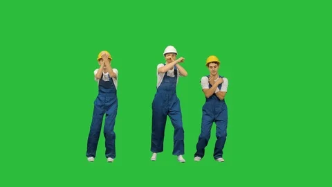 Three caucasian construction workers dancing on a Green Screen, Chroma Key. Stock Footage 125456936