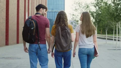 Three caucasian students walking through university campus Video stock 245432024