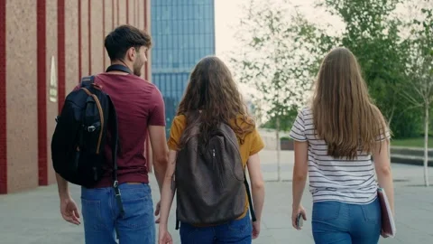 Three caucasian students walking through university campus Video stock 245470966