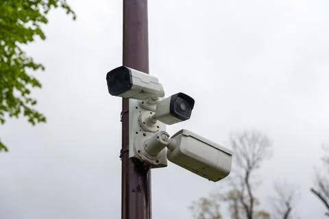 Three CCTV cameras mounted on a pole Stock Photos