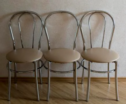 Three chairs on the background of the wall with wallpaper 写真素材