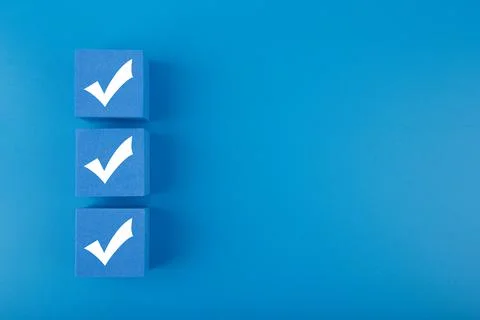 Three checkmarks on blue cubes against blue background with copy space Stock Illustration