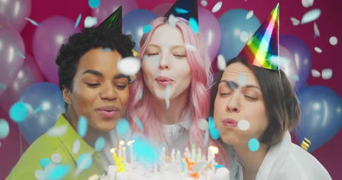 Three cheerful friendly diverse millennial women blowing candles on birthday Stock Footage 154220316