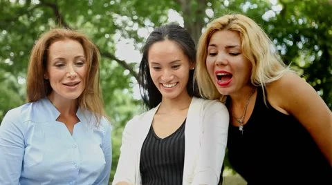 Three Cheerful Friends Looking at Pics on Phone Stock Footage 68511061