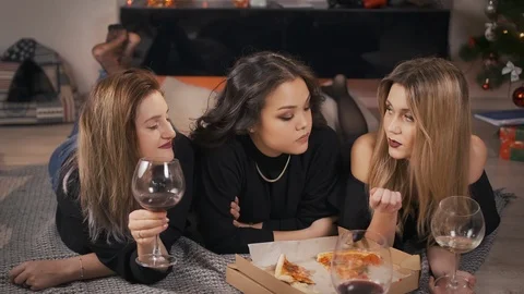 Three cheerful multi-racial friends, talking, fooling around and lying on the Stock Footage 101636965