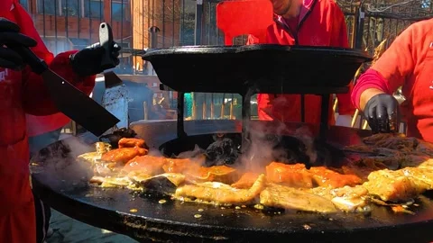 Three chefs are cooking seafood on the grill, three people are grilling fish Stock Footage 187729607