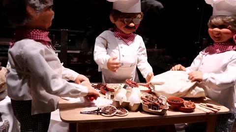 The three chefs bake bread on a Christmas shop window Stock Footage 63269021