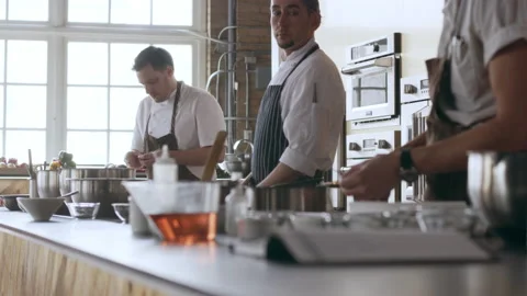 Three chefs washing their hands and standing by their stations ready to cook in Stock Footage 199456982