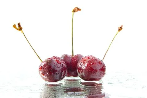 Three cherries Stock Photos
