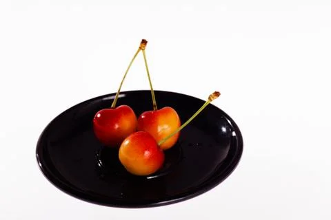 Three cherries Stock Photos