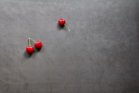 Three cherries Stock Photos