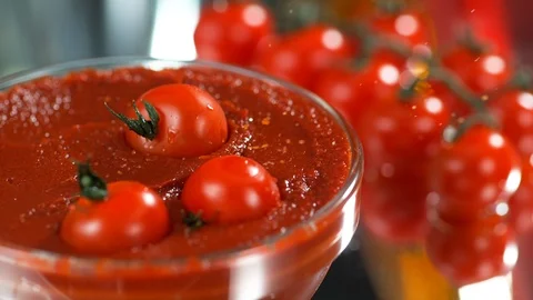 Three cherry tomatoes fall into tomato paste in SLOW MOTION, 4k, close up Stock Footage 114982285
