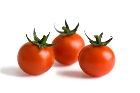 Three cherry tomatoes isolated Stock Photos