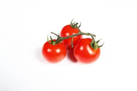 Three cherry tomatoes on white background Stock Photos