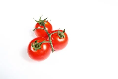 Three cherry tomatoes on white background Stock Photos