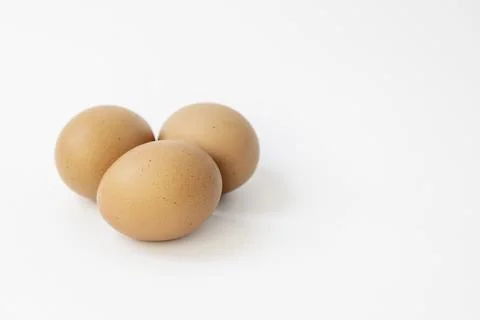Three chicken eggs isolate on white background. Stock Photos