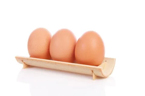 Three chicken eggs in a row Foto stock