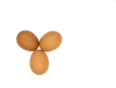 Three chicken eggs on white background Stock Photos