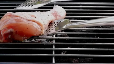 Three chicken legs cooking on charcoal oven Stock Footage 276374759