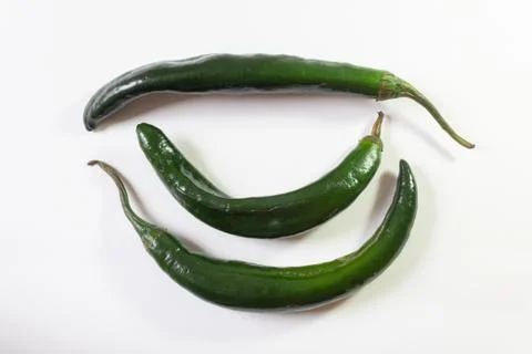 Three chilaca peppers, overhead view, isolated on white Stock Photos