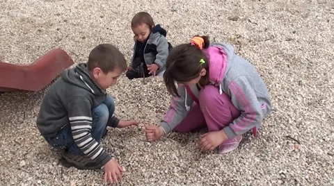 Three children are playing with sticks and stones, Crystal child Stock Footage 47788437