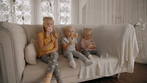 Three children eating candy snack on sticks Video stock 108548153