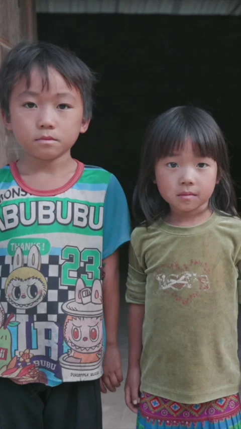 Three children in front of a house in  Yen Minh, Ha Giang, Vietnam Stock Footage 329254347