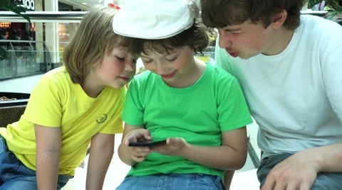Three children at the mall playing with tablet computer Video stock 66439651