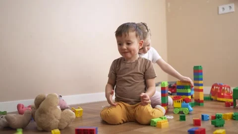 Three children playing with blocks. Children play together in a group. Build a Video stock 316604199