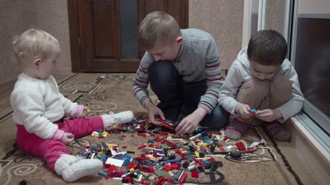 Three children playing with toys constructor Stock Footage 296370476