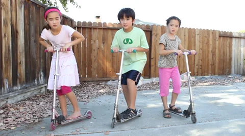Three Children Race Scooters Video stock 32165652