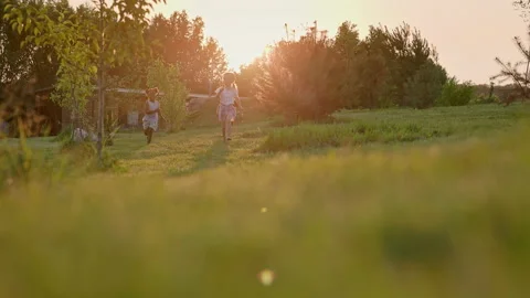 Three Children Run Through Garden. Beautiful Summer Sunny Day. Stock Footage 162622124