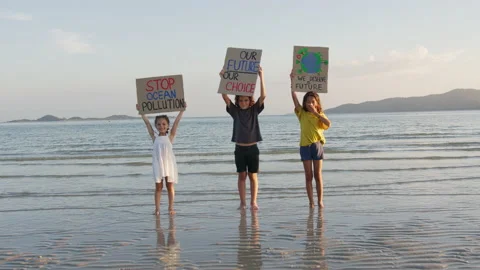 Three children standing on the seaside at sunset light against the backdrop of Video stock 191471941