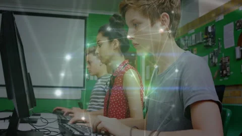 Three children typing in school computer lab activating network overlay showing Stock Footage 311885293