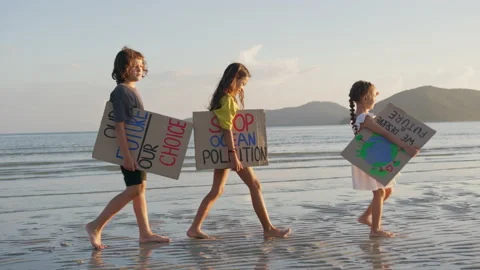 Three children walking on the seaside at sunset light against the backdrop of Stock Footage 191465443