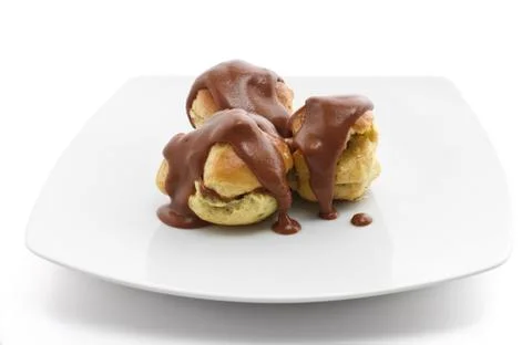 Three chocolate profiteroles Stock Photos