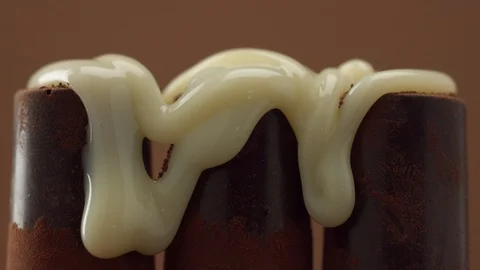 Three chocolate sweets covering by white sweet topping Stock Footage 86286018