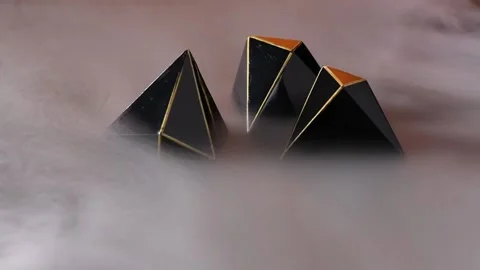 Three chocolates on a gold background surrounded by smoke. Stock Footage 132554748