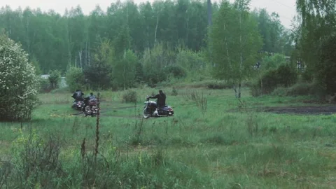Three choppers enter the forest on a dirt road Stock Footage 247901058