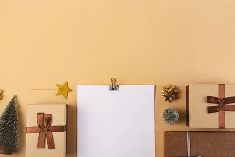 Three Christmas gift boxes on a neutral background among decorations Stock Photos