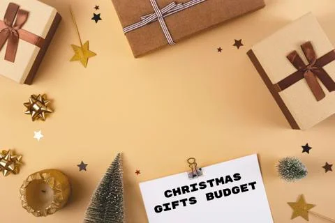 Three Christmas gift boxes on a neutral background among decorations Stock Photos