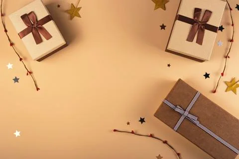 Three Christmas gift boxes on a neutral background among decorations Stock Photos