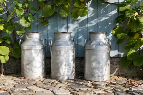 Three churns on a farm Stock Photos