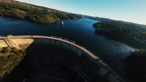 Three cinematic shots highlight grand dam and tranquil lake surrounded by trees Video stock 342272993