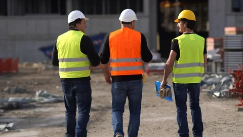 Three civil workers at the end of their work shift on construction site Stock Footage 87071173