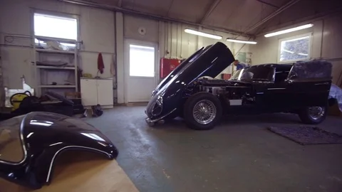 Three Classic Cars in a Workshop. Camera Moving Left. Cars Ready to Restore Stock Footage 77925898