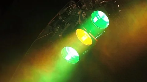 Three classic stage spotlights flash in the fog under the stage ceiling in a 스톡 동영상 155211469